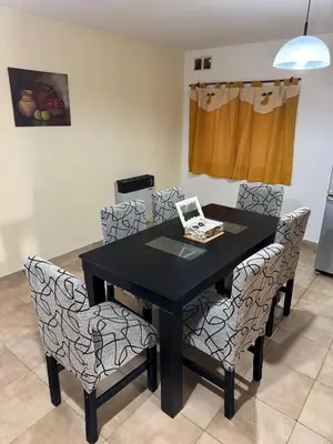 a black dining room table with chairs in a room at Apart Dinkendein de 2 dormitorios in Río Cuarto