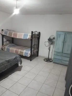 a room with two bunk beds and a fan at El portal in Cordoba