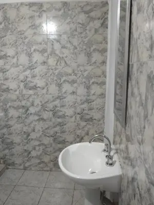 a bathroom with a sink and a stone wall at El portal in Cordoba