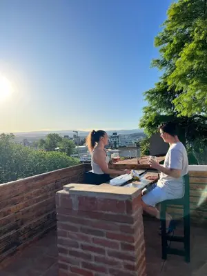 a man and a woman sitting at a table at Carlos Paz Hostel Lodge in Villa Carlos Paz