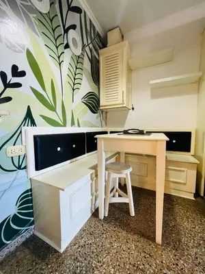 a kitchen with a table and a desk at Carlos Paz Hostel Lodge in Villa Carlos Paz