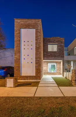 a brick building with a wall with a climbing wall at Dúplex en Manantiales in Cordoba