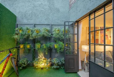 a room with a bunch of plants on a wall at Dúplex en Manantiales in Cordoba