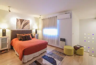 a bedroom with a bed and a television in it at Dúplex en Manantiales in Cordoba