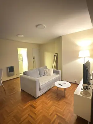 a living room with a couch and a table at Av Poeta Lugones - Nueva Córdoba in Cordoba