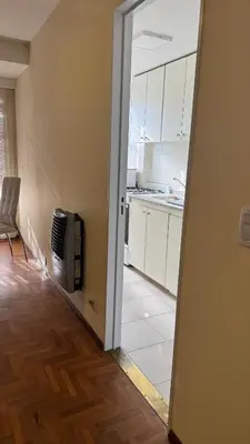 an open door to a kitchen with white cabinets at Av Poeta Lugones - Nueva Córdoba in Cordoba