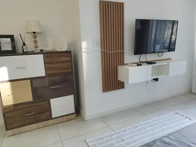 a living room with a television and a dresser at Departamento 1 dormitorio ubicado en zona estratégica de Nueva Córdoba in Cordoba