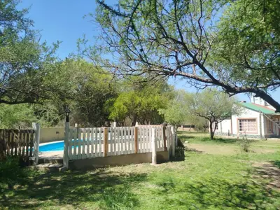 a white fence in front of a yard at Cabañas Chakra Raiz in Pantanillo