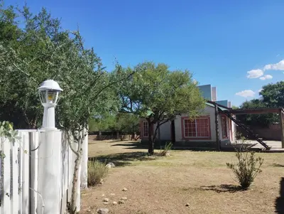 a white fence with a street light in front of a house at Cabañas Chakra Raiz in Pantanillo