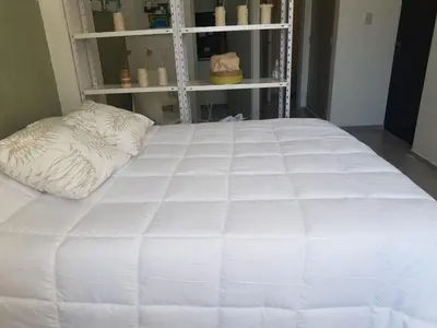 a large white bed in a room at Dean Funes - Distrito monoambiente in Cordoba