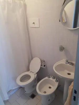 a bathroom with a toilet and a sink at Dean Funes - Distrito monoambiente in Cordoba
