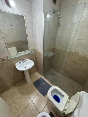 a bathroom with a shower and a toilet and a sink at Pringles - 1 dormitorio Bº General Paz in Cordoba