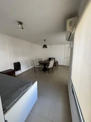 a room with a table and chairs and a bed at Pringles - 1 dormitorio Bº General Paz in Cordoba