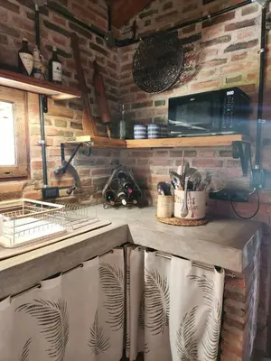 a kitchen with a counter with a sink and a stove at Descanso Serrano in Las Rabonas