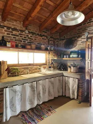 a kitchen with a sink and a counter with towels at Descanso Serrano in Las Rabonas
