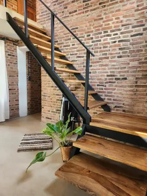 a brick wall and stairs in a room with a plant at Descanso Serrano in Las Rabonas