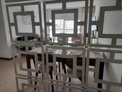 a dining room with a glass table and chairs at Costanera in Río Cuarto