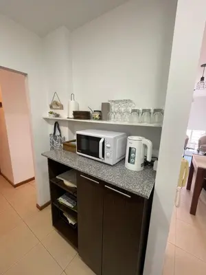 a kitchen with a counter with a microwave on it at Costanera in Río Cuarto