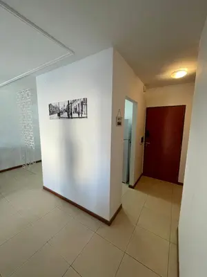 a hallway with a white wall with a picture on it at Costanera in Río Cuarto
