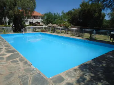 a large swimming pool with blue water at Hostería de los Césares in Merlo