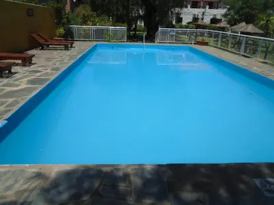 a large swimming pool with blue water at Hostería de los Césares in Merlo