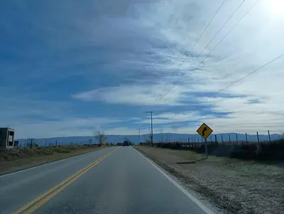 an empty road in the middle of a field at Kururu Cabaña en Villa Yacanto con vista a las sierras in Villa Yacanto