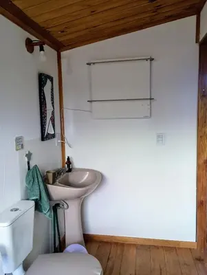 a bathroom with a sink and a toilet at Kururu Cabaña en Villa Yacanto con vista a las sierras in Villa Yacanto