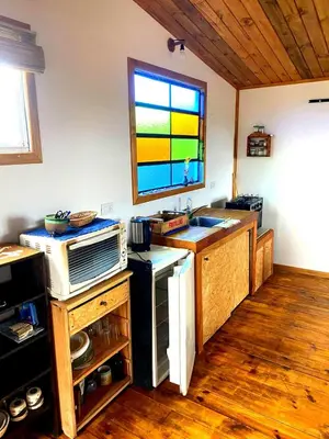 a kitchen with a sink and a window in a room at Kururu Cabaña en Villa Yacanto con vista a las sierras in Villa Yacanto