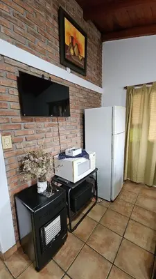 a living room with a refrigerator and a microwave at Casa Cian in Mina Clavero