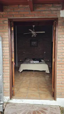 a room with a bed with a ceiling fan at Casa Cian in Mina Clavero