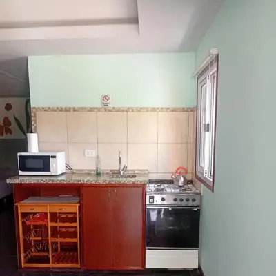a kitchen with a stove and a microwave at Suite's on the rock's in Nono