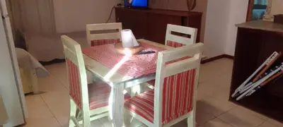 a table with two chairs and a candle on it at Suite's on the rock's in Nono
