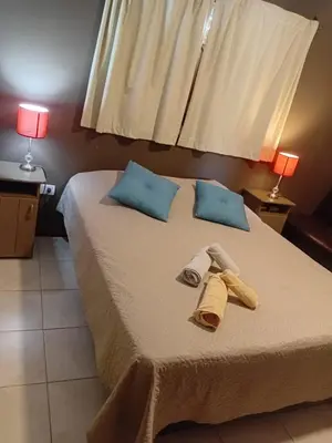 a bed with two towels and two lamps on it at Suite's on the rock's in Nono