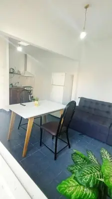 a table and a chair in a living room at Complejo La Tere- depto 3 in Cordoba