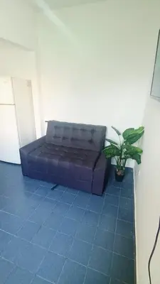 a blue couch in a room with a potted plant at Complejo La Tere- depto 3 in Cordoba