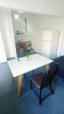 a white table and a chair in a room at Complejo La Tere- depto 3 in Cordoba