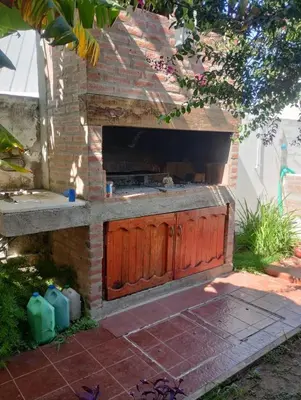 a outdoor kitchen with a brick oven in a yard at Complejo La Tere- depto 3 in Cordoba