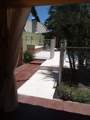 a fenced in yard with a fence and a house at Complejo La Tere- depto 3 in Cordoba