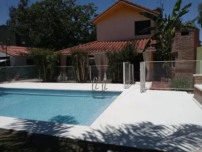 a swimming pool in front of a house at Complejo La Tere- depto 3 in Cordoba