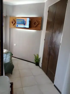 a bedroom with a door and a tiled floor at Departamento con hermosa vista en Carlos Paz in La Cuesta