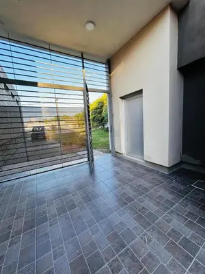 an empty room with a large sliding glass door at Confortable Casa en Pilar Rio II in Pilar