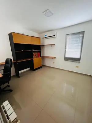 an office with a desk and a chair in a room at Confortable Casa en Pilar Rio II in Pilar