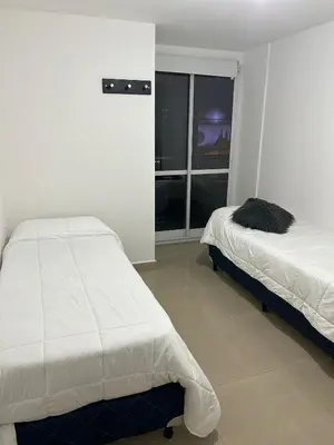 a bedroom with two beds and a window at Miradores del buen pastor - Nueva cordoba in Cordoba