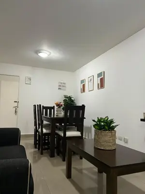 a living room with a table and chairs at Miradores del buen pastor - Nueva cordoba in Cordoba