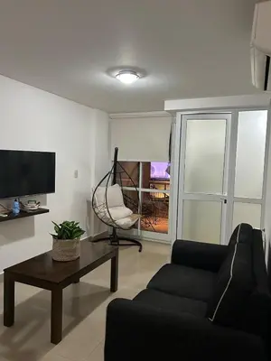 a living room with a couch and a chair at Miradores del buen pastor - Nueva cordoba in Cordoba