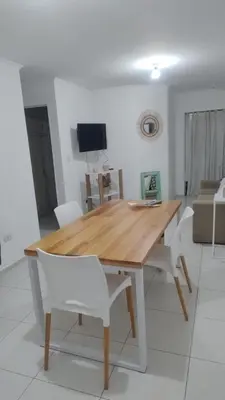 a wooden table and chairs in a living room at Departamento amplio, Zona Nueva Cba , A cien metros de la terminal Buss in Cordoba
