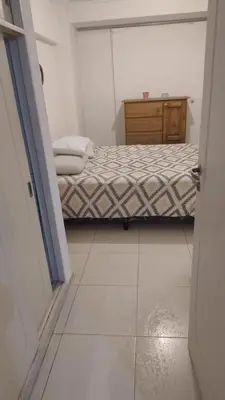 a small bedroom with a bed and a dresser at Departamento amplio, Zona Nueva Cba , A cien metros de la terminal Buss in Cordoba
