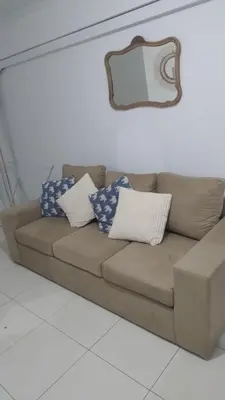 a brown couch with pillows on it in a room at Departamento amplio, Zona Nueva Cba , A cien metros de la terminal Buss in Cordoba