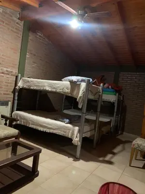 two bunk beds in a room with a ceiling at Los nonos in Villa Los Aromos