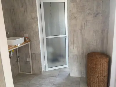 a bathroom with a glass shower and a sink at Departamento in Alta Gracia
